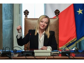 Giorgia Meloni, Italy's new prime minister, rings a bell during her first cabinet meeting at Chigi Palace in Rome.