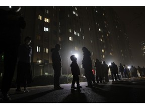 People wait in line at night for a swab test at a COVID-19 testing site in Beijing on November 20. Photographer: Lintao Zhang/Getty Images