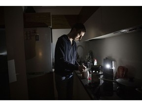 KYIV, UKRAINE - NOVEMBER 06: IT worker Igor, who normally uses en electric hob, makes tea using a camping stove in his apartment block in near total darkness during a scheduled power cut on the left bank of the River Dnipro November 06, 2022 in Kyiv, Ukraine. Electricity and heating outages across Ukraine caused by missile and drone strikes to energy infrastructure have added urgency preparations for winter.