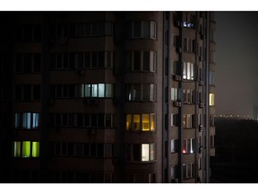 KYIV, UKRAINE - NOVEMBER 06: Apartment blocks stand in near total darkness during a scheduled power cut on the left bank of the River Dnipro November 06, 2022 in Kyiv, Ukraine. Electricity and heating outages across Ukraine caused by missile and drone strikes to energy infrastructure have added urgency preparations for winter.