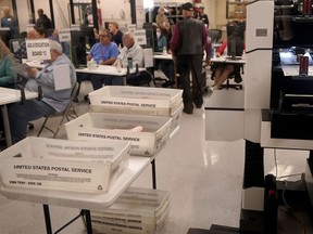 Adjudicators observe as ballots are tabulated inside the Maricopa County Recorders Office, Wednesday, Nov. 9, 2022, in Phoenix.