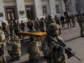 Ukrainian President Volodymyr Zelensky guarded by soldiers, gives a speech in Kherson, southern Ukraine, Monday, Nov. 14, 2022. Ukraine's retaking of Kherson was a significant setback for the Kremlin and it came some six weeks after Russian President Vladimir Putin annexed the Kherson region and three other provinces in southern and eastern Ukraine -- in breach of international law -- and declared them Russian territory.