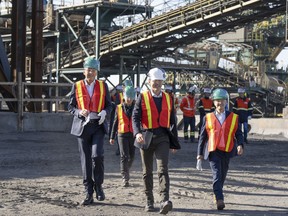 Prime Minister Justin Trudeau arrives with Rio Tinto chief executive Jakob Stausholm, left, and Industry Minister Francois-Philippe Champagne, right, for a tour of a new pilot project for a blue smelting facility at the Rio Tinto plant, last month in Sorel, Que.