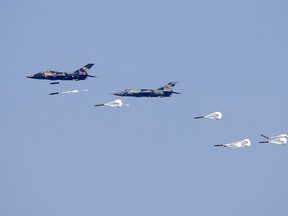 FILE - Myanmar Air Force Jet fighters drop bombs during military exercises Friday, Feb. 2, 2018, in Ayeyarwaddy delta region, Myanmar. In a report released Thursday, Nov. 3, 2022, Amnesty International is urging suppliers of aviation fuel to Myanmar to suspend such shipments to prevent the military from using them to conduct air attacks on civilian targets as the number of bombings has increased.