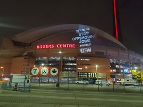 United Steelworkers union shines a spotlight on Telus' offshoring of jobs, at the Rogers Centre in Toronto.