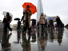 Commuters walk across London Bridge toward the financial district in September.