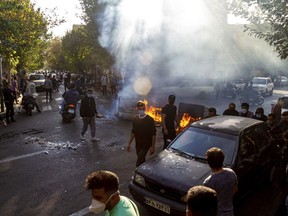 In this photo taken by an individual not employed by the Associated Press and obtained by the AP outside Iran, Iranians protests the death of 22-year-old Mahsa Amini after she was detained by the morality police last month, in Tehran, Thursday, Oct. 27, 2022. (AP Photo/Middle East Images, File)