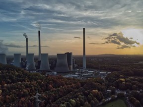FILE - The sun sets behind the cole-fired power plant 'Scholven' of the Uniper energy company in Gelsenkirchen, Germany, Oct. 22, 2022. The European Union's executive commission slashed its forecast for economic growth next year. It says that the 19 countries that use the euro currency will slide into recession over the winter as peak inflation hangs on for longer than expected and high fuel and heating costs erode consumer purchasing power.