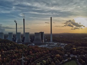 FILE - The sun sets behind the cole-fired power plant 'Scholven' of the Uniper energy company in Gelsenkirchen, Germany, Oct. 22, 2022. The European Union's executive commission slashed its forecast for economic growth next year. It says that the 19 countries that use the euro currency will slide into recession over the winter as peak inflation hangs on for longer than expected and high fuel and heating costs erode consumer purchasing power.