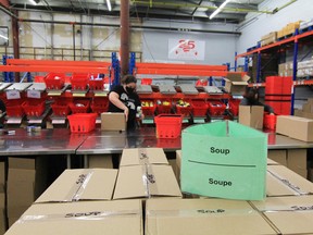 Volunteers fill boxes with donated food at the Ottawa Food Bank warehouse in Ottawa.