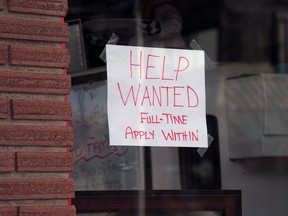 A help wanted sign in a restaurant window in Calgary.