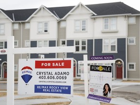 Houses for sale are shown in a new subdivision in Airdrie, Alta., Friday, Jan. 28, 2022. The Calgary Real Estate Board says October home sales in the region fell by 15 per cent since last year but remained above pre-pandemic levels and were coupled with price increases.