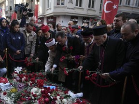 Representatives of the Turkish communities put flowers over a memorial placed on the spot of Sunday's explosion on Istanbul's popular pedestrian Istiklal Avenue in Istanbul, Turkey, Wednesday, Nov. 16, 2022.Turkish police said Monday they have detained a Syrian woman with suspected links to Kurdish militants and that she confessed planting a bomb that exploded on a bustling pedestrian avenue in Istanbul, killing six people and wounding several dozen others.
