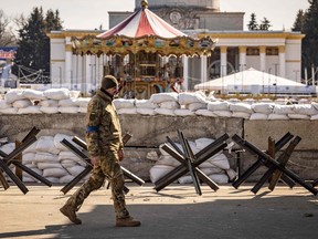 A member of the Ukrainian Territorial Defence Forces stands guard at a checkpoint in Kyiv on March 20, 2022.