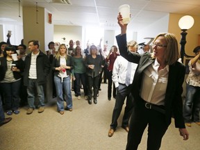 FILE - Star Tribune editor Nancy Barnes, gives a toast to Star Tribune reporters Brade Schrade, Jeremy Olson and Glenn Howatt along with editorial cartoonist Steve Sack after the newspaper won two Pulitzer Prizes on April, 15, 2013, in Minneapolis. The Boston Globe named Barnes as its next editor on Monday, Nov. 14, 2022, elevating a woman to serve in the top job for the first time in the newspaper's 150-year history.