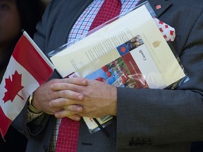 A new Canadian attends a citizenship ceremony in Vancouver. New selection tools will allow Canadian officials to select immigrants to fill job gaps in specific industries and regions.