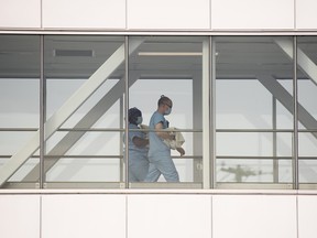 Health-care workers walk across a sky bridge at a hospital in Montreal.