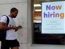 A 'Now hiring' sign hangs near the entrance to a Fedex store in Miami Beach, Florida. 