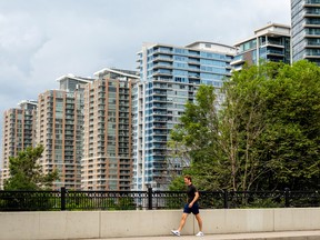A pedestrian walks past condo buildings in the Liberty Village neighbourhood in Toronto.