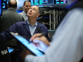 Traders work on the floor of the New York Stock Exchange.