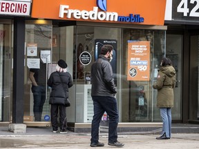 Patrons shop at a Freedom Mobile location on Toronto’s Queen Street West.