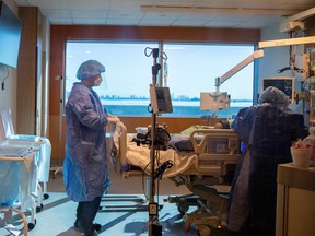 An ICU doctor Spiegelman speaking to a patient at the Humber River Hospital in Toronto.
