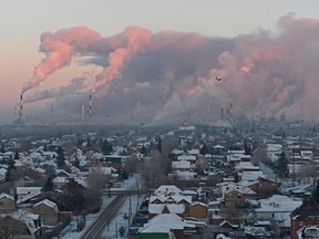 Steam rises from chimneys of the Gazprom Neft's oil refinery in Omsk, Russia.