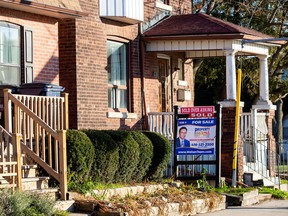 A 'for sale' sign displayed outside a home in Toronto.