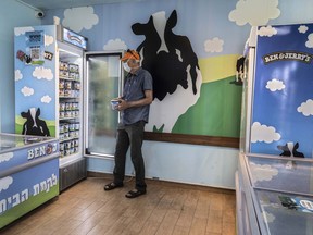 FILE - An Israeli shops at the Ben & Jerry's ice-cream factory in the Be'er Tuvia Industrial area on July 20, 2021. Ben & Jerry's board of directors on Tuesday, Nov. 15, 2022, rebuked the sale of products bearing any of the ice cream maker's insignia in West Bank settlements, the latest salvo in the Vermont-based company's feud with its corporate parent over ice cream sales in the territories.