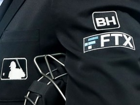 FILE - The FTX logo appears on a home plate umpire's jacket at a baseball game with the Minnesota Twins on Sept. 27, 2022, in Minneapolis. Collapsed cryptocurrency trading firm FTX confirmed there was "unauthorized access" to its accounts, hours after the company filed for Chapter 11 bankruptcy protection Friday, Nov. 11, 2022.