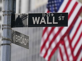 FILE - A street sign is seen in front of the New York Stock Exchange in New York, Tuesday, June 14, 2022. AP Photo/Seth Wenig, File)