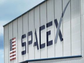 FILE - The SpaceX logo is displayed on a building, Tuesday, May 26, 2020, at the Kennedy Space Center in Cape Canaveral, Fla. Several SpaceX employees who were fired after circulating an open letter calling out CEO Elon Musk's behavior have filed a complaint accusing the company of violating labor laws. The complaint, made Wednesday, Nov. 16, 2022, to the National Labor Relations Board, says five employees who participated in organizing the June letter were fired a day after the letter was sent to company executives.