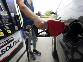 A customer readies to pump gas.