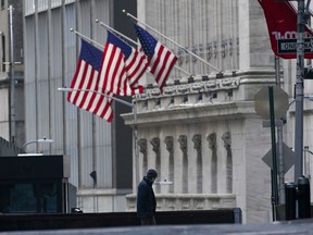 FILE - A security guard is seen next to a road block near the New York Stock exchange, Friday, Jan. 14, 2022, in the Financial District.