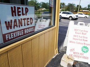 FILE - A help wanted sign is displayed in Deerfield, Ill., Wednesday, Sept. 21, 2022. The U.S. government will issue the October jobs report on Friday morning.
