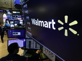 FILE - In this Feb. 18, 2020 file photo, the logo for Walmart appears above a trading post on the floor of the New York.  Walmart reports quarterly financial results reports quarterly financial results Tuesday, Nov. 15, 2022.