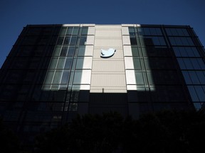 FILE - A Twitter logo hangs outside the company's San Francisco offices on Tuesday, Nov. 1, 2022. Reacting to the tumult and mass layoffs at Twitter under its new owner Elon Musk, a group of Democratic senators on Thursday, Nov. 17, 2022, asked federal regulators to investigate any possible violations by the platform of consumer-protection laws or of its data-security commitments.