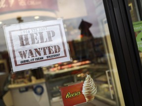 A help wanted sign in a storefront, Tuesday, Nov. 1, 2022, in Bedford, N.Y. The Federal Reserve may reach a turning point this week as it announces what's expected to be another substantial three-quarter-point hike in its key interest rate. The Fed's hikes have already led to much costlier borrowing rates, ranging from mortgages to auto and business loans.