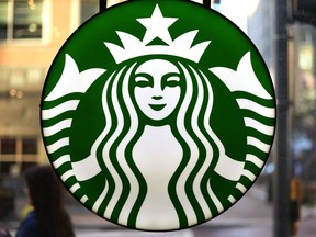 FILE - The Starbucks logo is displayed in the window of a downtown Pittsburgh Starbucks on Monday, Nov. 7, 2022. Workers at more than 100 U.S. Starbucks stores are scheduled to go on strike Thursday, Nov. 17, the same day the company plans its annual giveaway of reusable holiday cups.