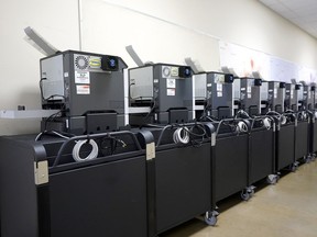 FILE - Affidavit printers are lined up at the Maricopa County Elections Department in Phoenix, Sept. 8, 2022. Big tech platforms say they are working hard to address misinformation about voting and elections ahead of the November midterms, but a look at their sites shows they are still struggling to contend with false claims from 2020.