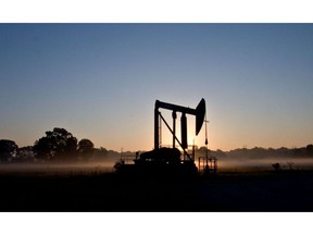 An oil derrick is silhouetted by early morning sunlight as it pumps oil from a field in Alsen, Louisiana, US. Photographer: JB Reed/Bloomberg