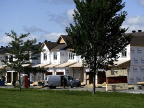 Homes under construction are seen in a new subdivision in the Ottawa suburb of Kanata, on Friday, July 30, 2021. First-time homebuyers in Canada are facing one of the toughest real estate markets in generations.