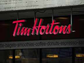 Tim Hortons signage is pictured in Ottawa on Wednesday Sept. 7, 2022. Tim Hortons' parent company recorded higher sales and profit in its most recent quarter despite 'macroeconomic pressures' weighing on the restaurant industry.