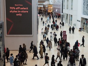 People navigate through Yorkdale Mall in search of Black Friday sales in Toronto on Friday, Nov. 26, 2021. In-store shopping to make comeback this Black Friday as holiday budgets shrink.THE CANADIAN PRESS/Tijana Martin