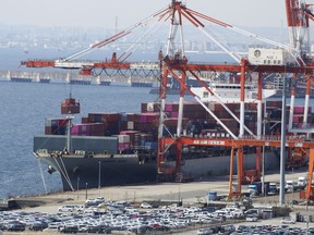 A container ship is loaded and unloaded at a container terminal at a port of Kawasaki near Tokyo on March 9, 2022. Japan marked a trade deficit for the 15th month in a row in October, government data showed Thursday, Nov. 17, 2022, as both imports and exports reached record highs amid soaring costs of energy and food, coming on top of the drooping value of the yen.