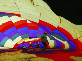 A ground grew member walks inside a hot air balloon as it being inflate before Balloona Palooza's early morning launch at the Richard M. Borchard Regional Fairgrounds on Saturday, Oct. 22, 2016. Pilots of hot air balloons carrying paying passengers will need medical certificates, just like pilots of other kinds of commercial aircraft. That's according to a final rule that the Federal Aviation Administration adopted Wednesday, Nov. 16, 2022.