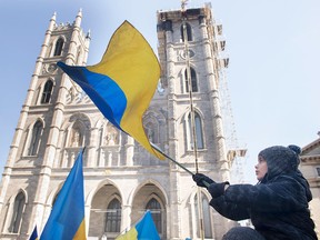 A child waves a Ukrainian flag during a rally in support of Ukraine in Montreal.