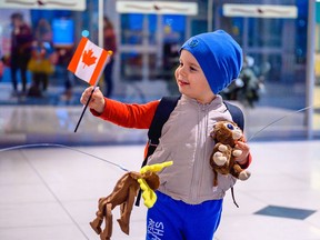 A Ukrainian newcomer with their first Canadian flag.