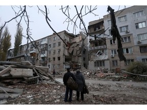 Local residents looks at a damaged residential building after a strike in Mykolaiv on November 11. Photographer: Anatolii Stepanov/AFP/Getty Images