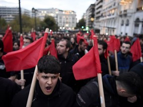 Protestors march as they shoot slogans during a rally, in Athens, Greece, Thursday, Nov. 17, 2022. Around 5,000 police were expected to be deployed in the Greek capital, where major streets were to be blocked to traffic and three subway stations along the march route shut down afternoon. In 1973, the military regime that had been in power since 1967 sent police and troops to crush student-led pro-democracy protests centered in the Athens Polytechnic.